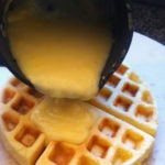 Adding the Hollandaise sauce to the waffle crust
