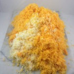 The pile of 19 different shredded Wisconsin cheeses.